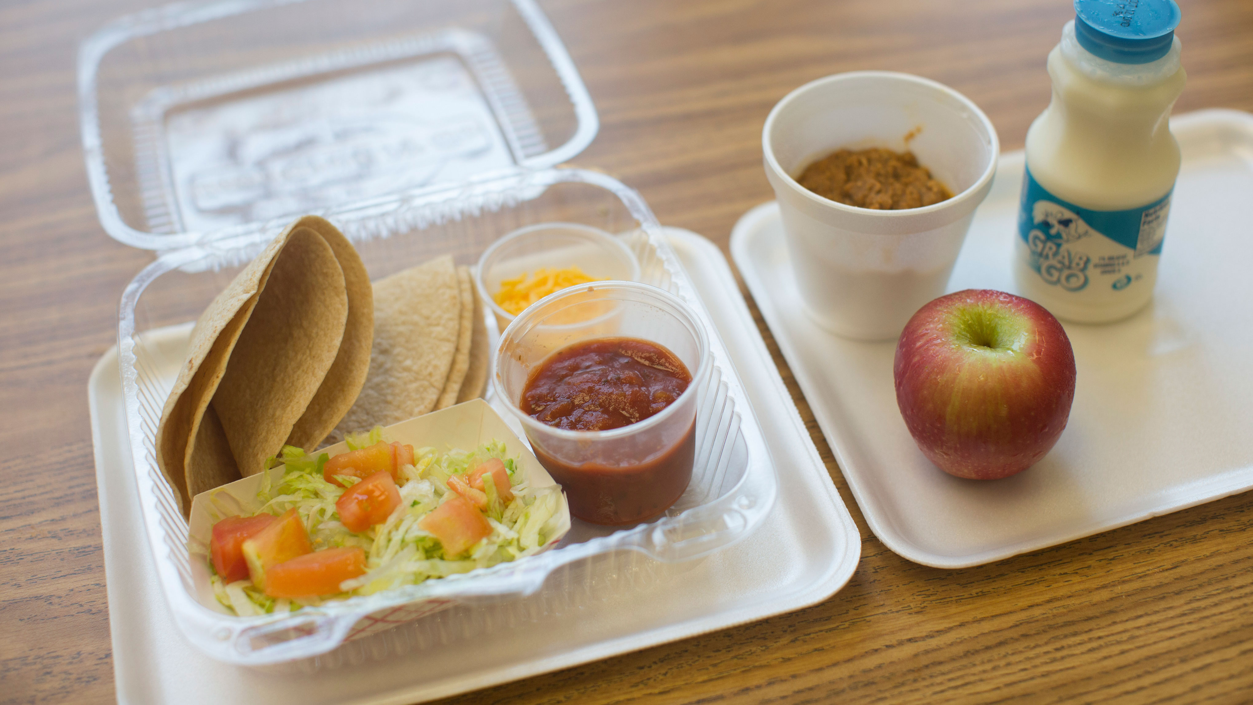 Cafeteria staff prepare school lunches for students