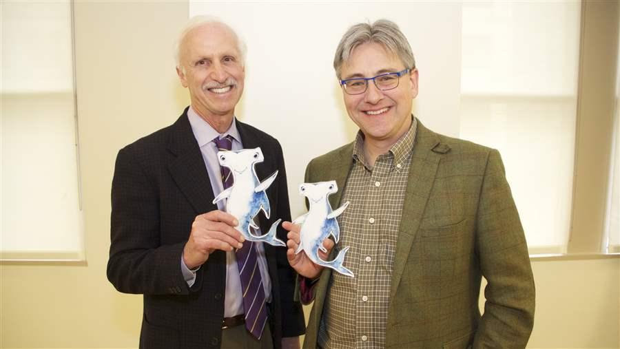 Josh Reichert (left), Pew’s executive vice president, with Pew Marine Fellow Dr. Callum Roberts, and two Shark Stanleys