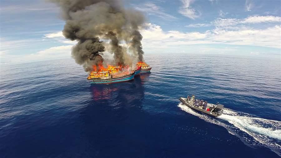 burning illegal fishing vessel and government boat in Palau
