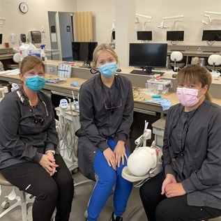 Dental therapy students Amanda Weyek, Rachel Wangen, and Cindy Degner, left to right, in the Minnesota State University-Mankato Dental Simulation Lab.