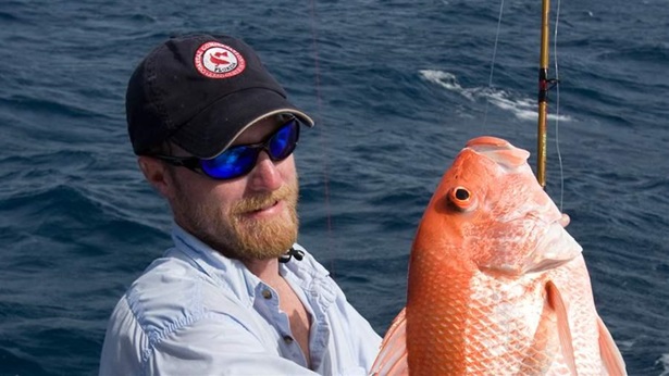 Fisherman holding Adult Red Snapper