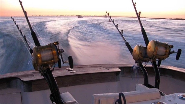 Close up of fishing rods on boat at sunrise Mexico