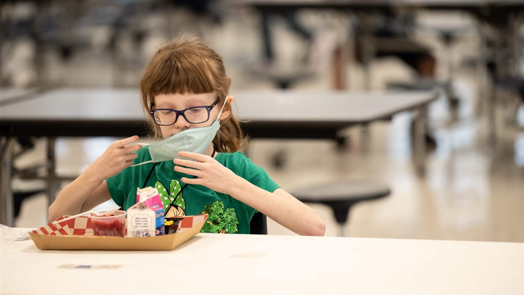 Child at school cafeteria lunch table