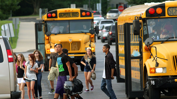 Students step outside of a school bus. (AP)