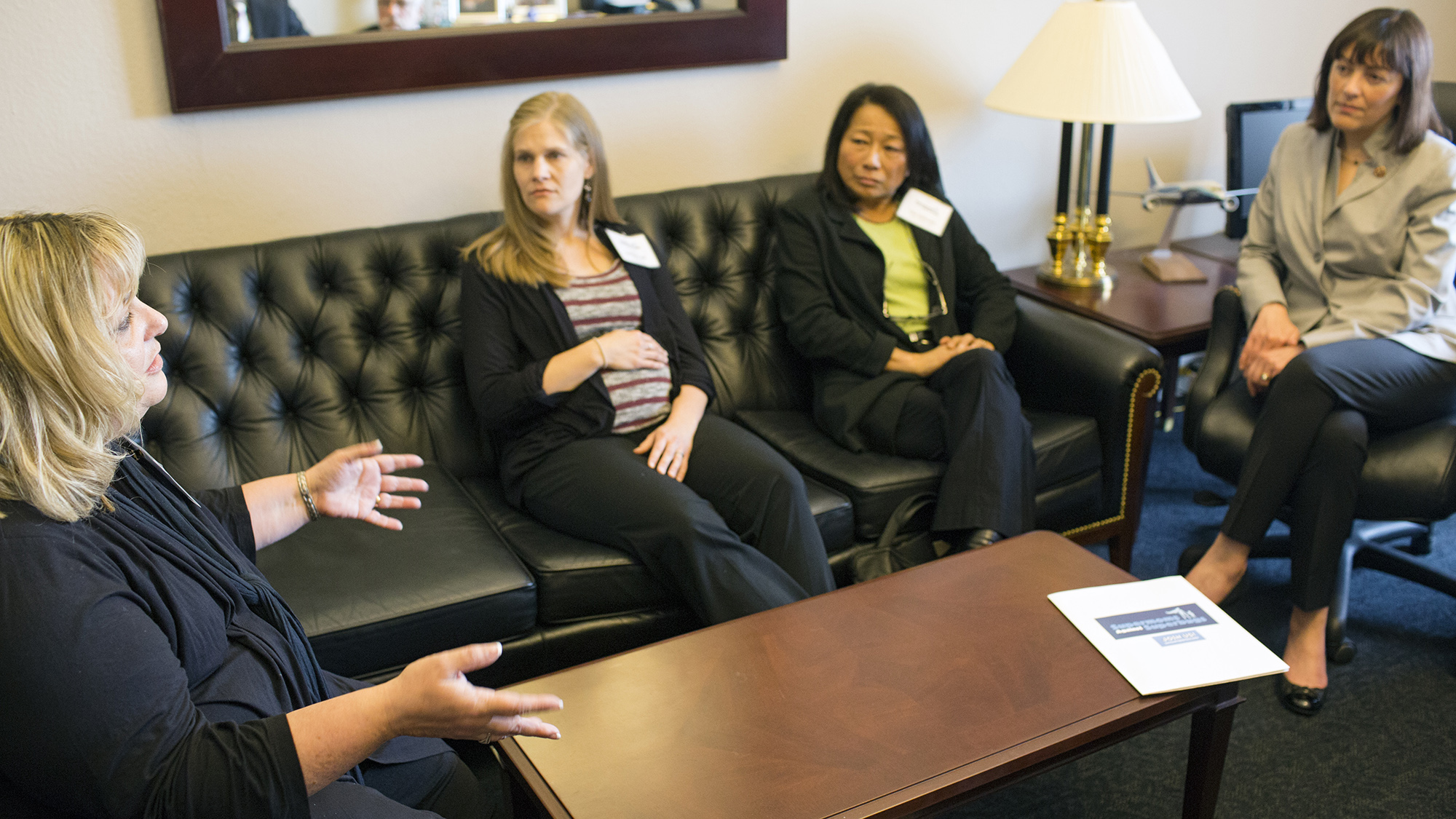 Cheryl Perron (left), whose son lost his leg and nearly his life due to an antibiotic-resistant infection, talks about the need for stronger regulation to end the overuse of antibiotics in agriculture with Representative Suzan DelBene (D-WA) (right). With Perron are Bethany Cook (center left), a registered dietitian, and Eiko Vojkovich, an organic farmer.