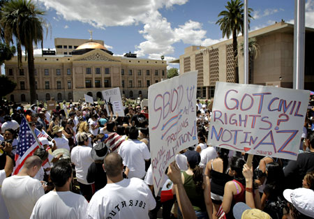 Protesters gather outside the Arizona Capitol Saturday, May 1, 2010 in Phoenix to protest Arizona's controversial new immigration bill. Opponents claim the law will lead to more racial profiling of Hispanics by police, even though the law expressly forbids it. 