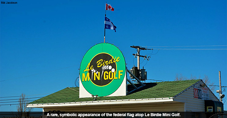 A rare, symbolic appearance of the Canadian flag atop Le Birdie Minigolf.