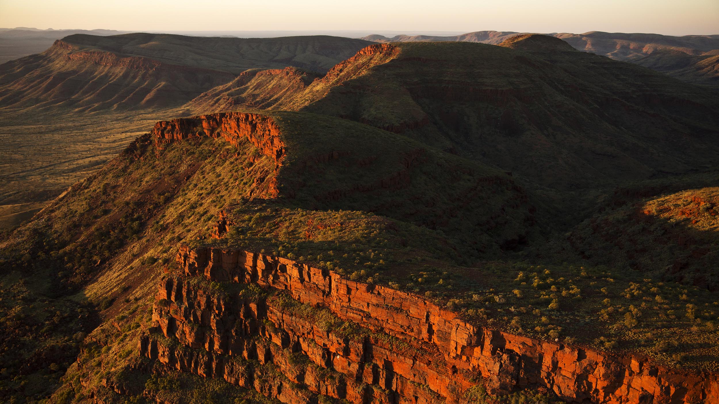 A typical Pilbara landscape of mesas, escarpments, rolling hills and spinifex grasslands at Mount Frederick, Western Australia.