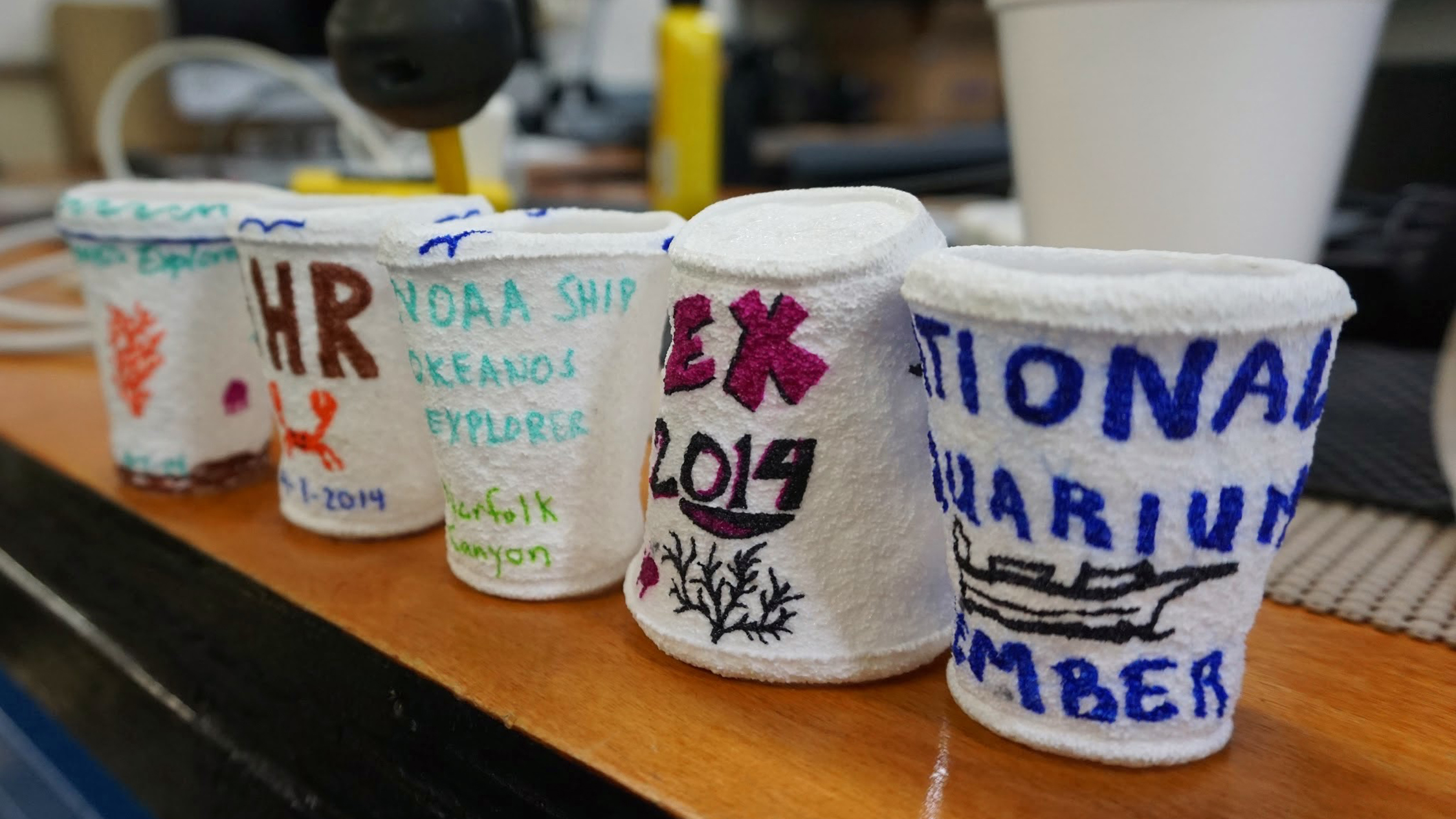 A rite of passage: Each Okeanos guest drew on a plastic foam cup. After the cups were submerged at 2,200 feet, the water pressure shrank them to one-third of their original size. 