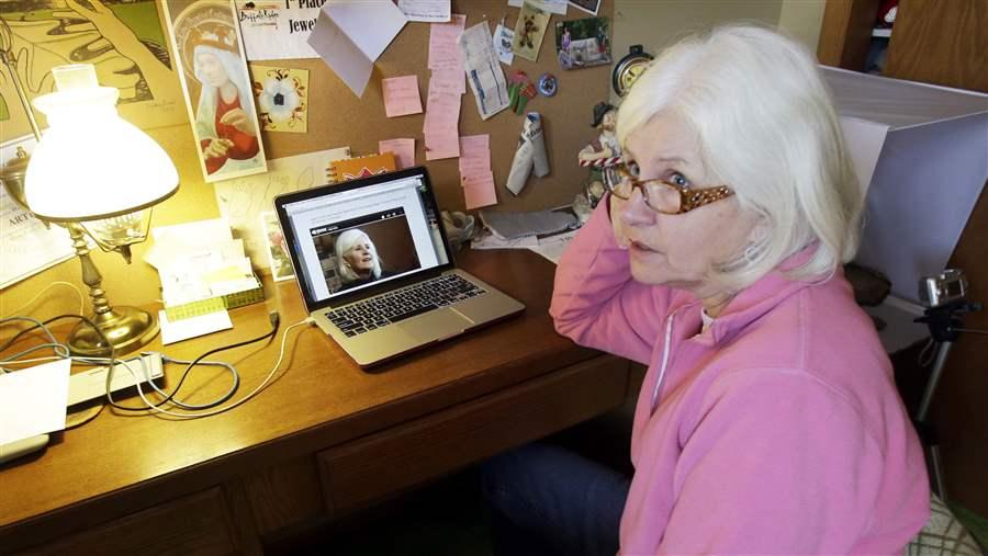 Jean Menden uses a laptop to run an online business.