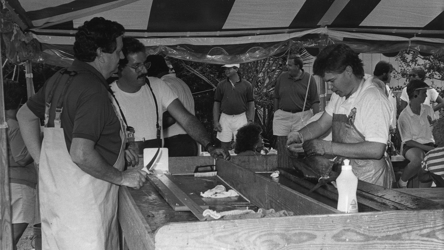 While serving as director of North Carolina’s fish policy in the 1980s, Hogarth (left) spends a day inspecting fish that are collected for study. 