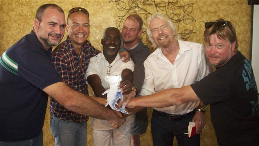 Sir Richard Branson (second from right) and friends celebrate shark conservation with Shark Stanley in Bimini, The Bahamas