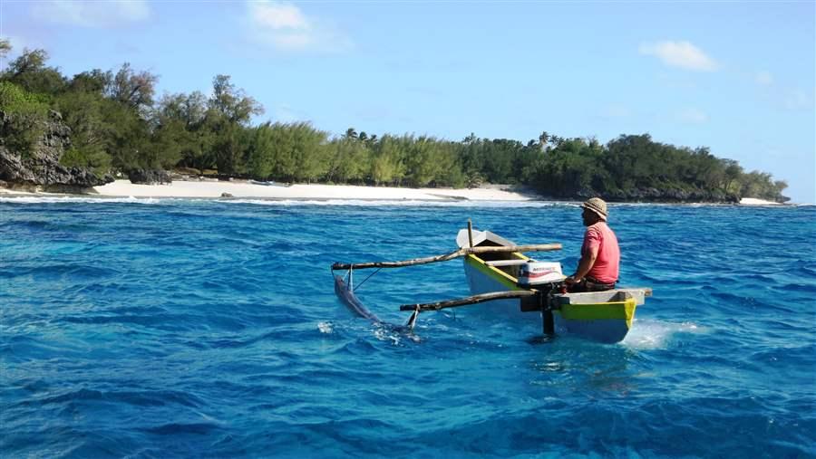 Local fisherman in a traditional canoe off Rimatara.