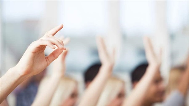 classroom students raising hands