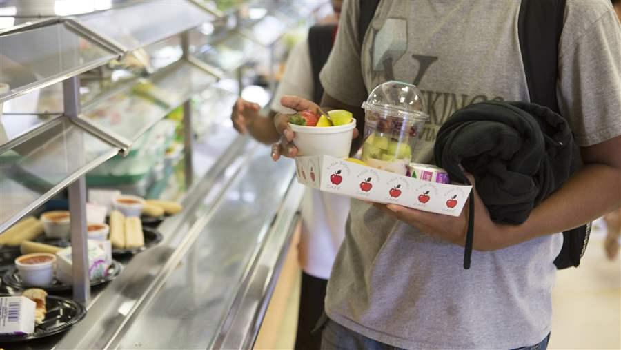 Boy buying cafeteria lunch