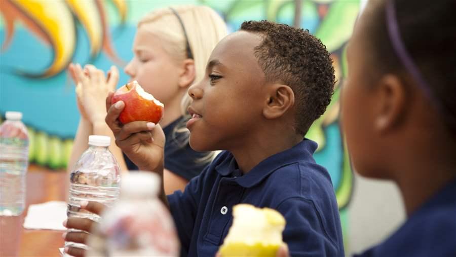 Student eating an apple