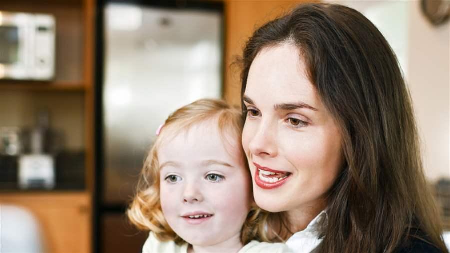 Mother sitting with her child at a computer.