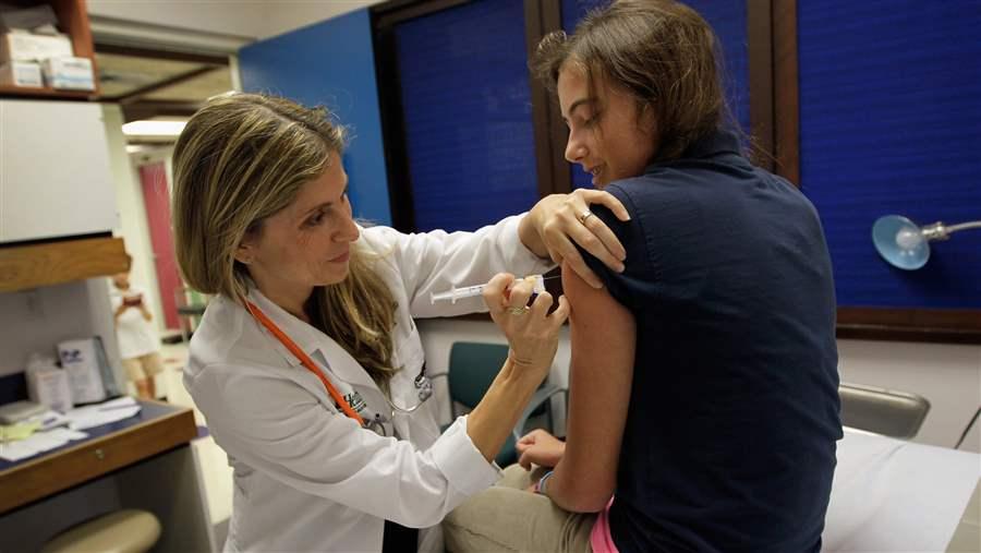 Miami pediatrician administers an HPV vaccination 