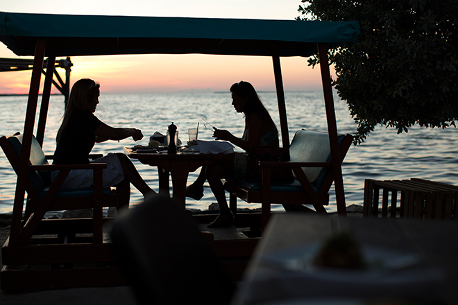 People eating by the Caribbean Ocean