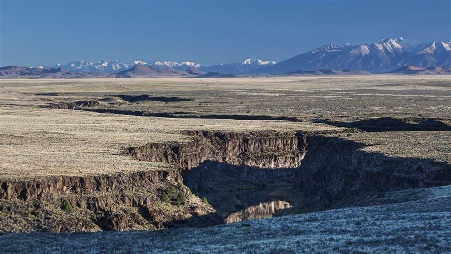 Volcanic cones, vast plains, and steep canyons give way to an 800-foot-deep gorge in the Río Grande del Norte National Monument in New Mexico.  An important migratory bird flyway, the monument is a nesting habitat for raptors, including golden eagles. Rocky Mountain bighorn sheep, elk, mule deer, and pronghorn antelope make their winter homes here.