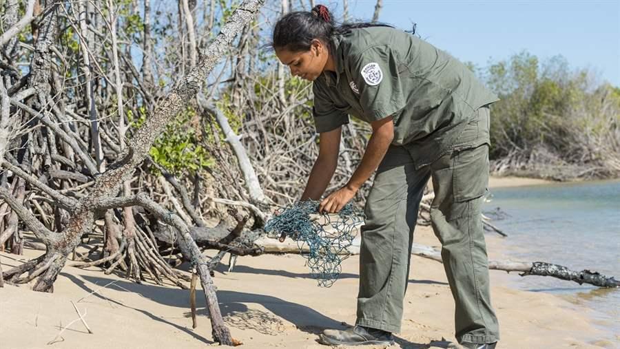 An Indigenous Ranger removes a ‘ghost net’