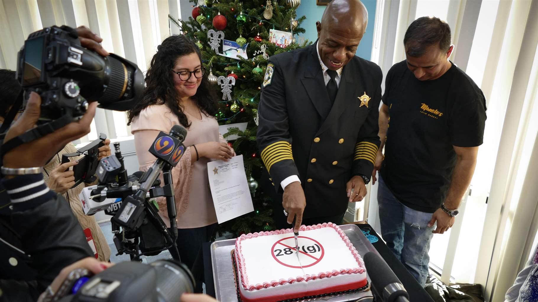 Sheriff Garry McFadden of Mecklenburg County, North Carolina, celebrates his election in November by slicing a cake frosted with a message in protest of 287(g), the federal immigration enforcement and deportation program he pledged to end in the county. An increase in arrests related to the program is losing steam as more big-city sheriffs back out of it, even as more smaller counties in conservative areas join up.