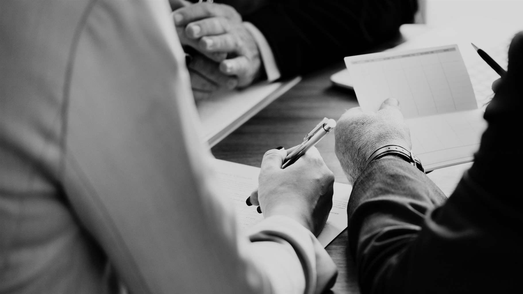 Businessmen talking over papers