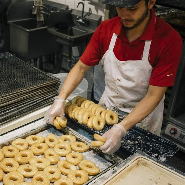 Baker making doughnuts