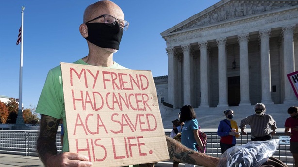 ACA supporter with sign