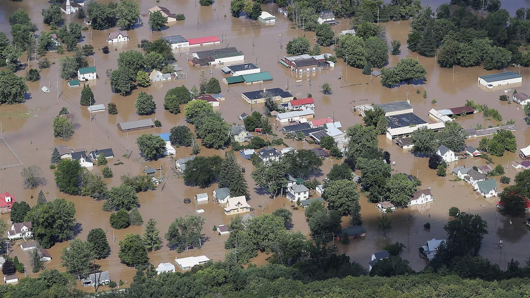 In this Aug. 29, 2018, file photo, flooding is seen in Gays Mills, Wis., following torrential rains that sent the Kickapoo River over its banks the two previous days. Politics dominated Wisconsin&#39;s year in news, with voters deposing Gov. Scott Walker in a midterm kind to Democrats. Walker and leading Republicans didn&#39;t go quietly, drawing national attention for maeneuvering to block their successors from undoing some major policy achievements. The western Wisconsin community of Barron struggled to understand the disappearance of a teenage girl, and much of central and southern Wisconsin dealt with costly damage from widespread flooding. 