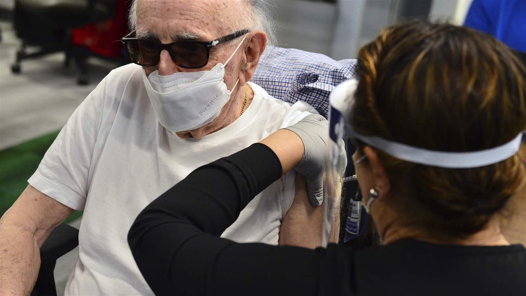 Man receiving vaccine Man receiving vaccine