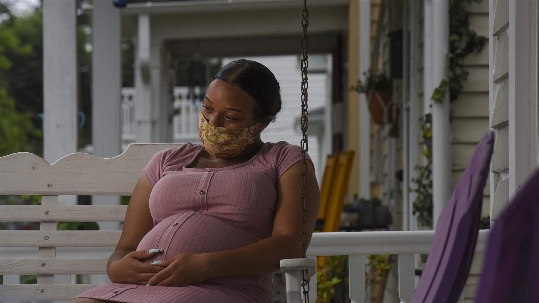 Woman on porch with mask