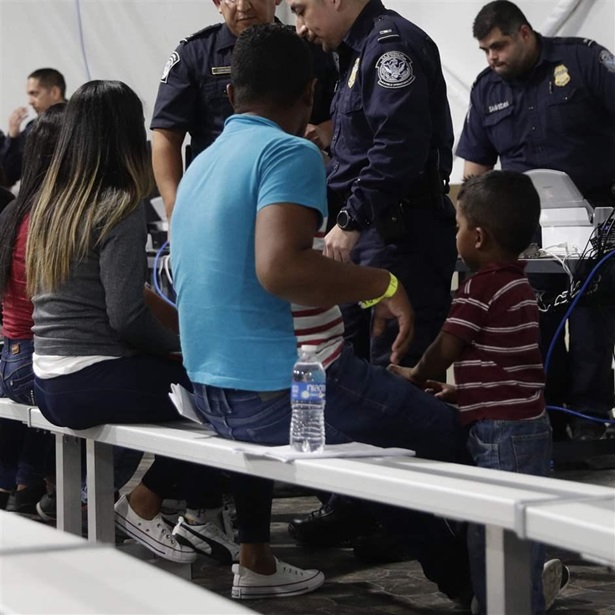 Migrants wait to apply for asylum