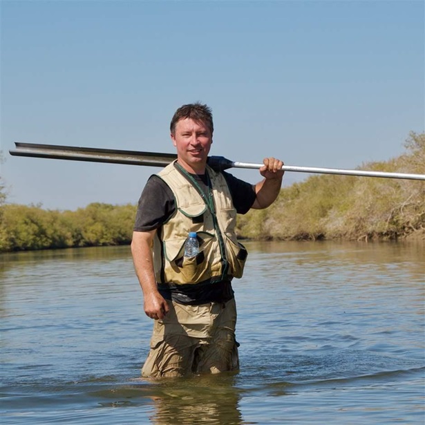 Steve Crooks holding equipment in water in Khor Kalba