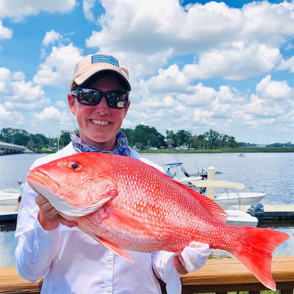 Kellie Ralston holds a red snapper