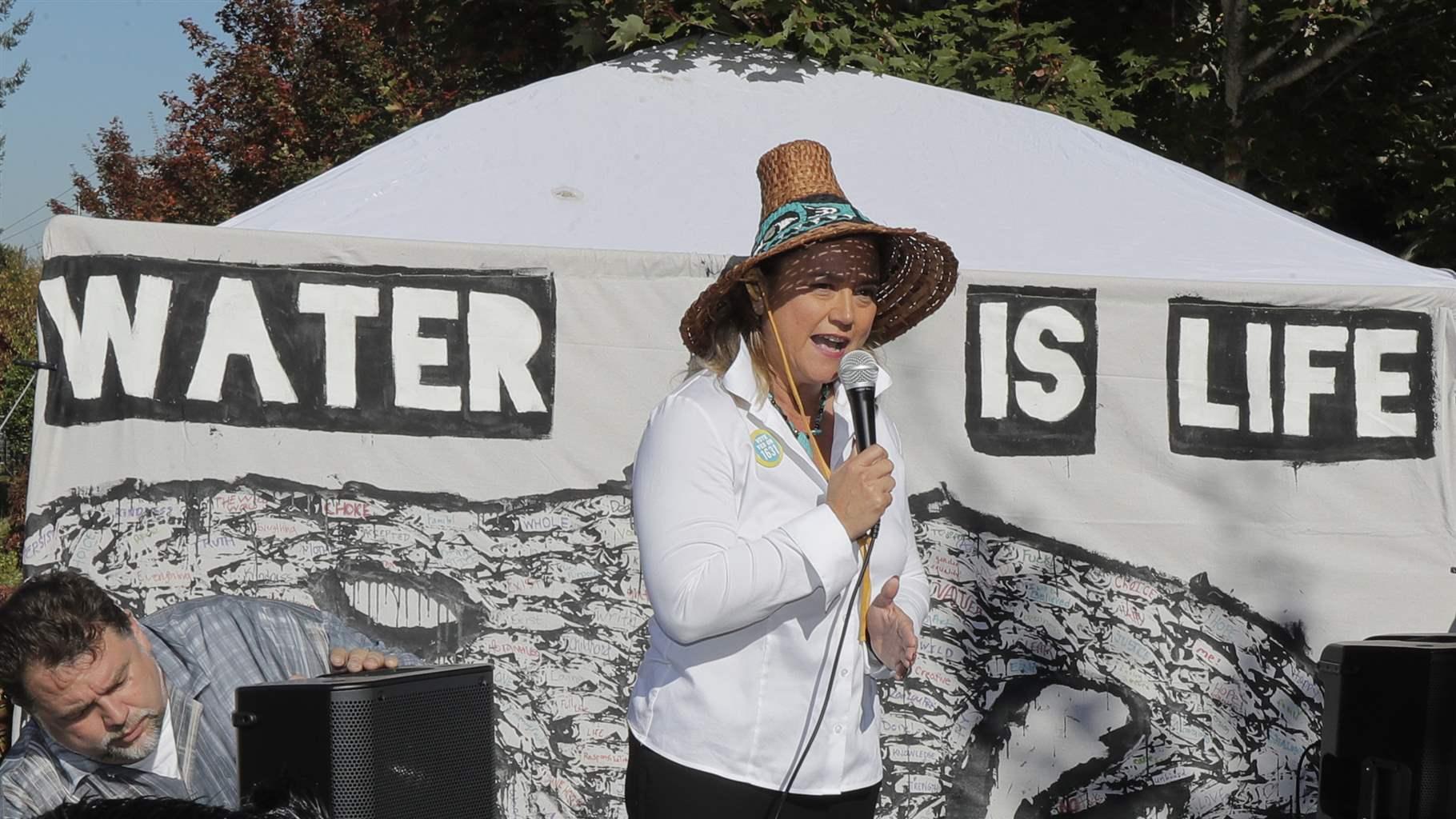 Fawn Sharp, President of the Quinault Indian Nation, speaks Wednesday, Oct. 17, 2018, at a rally supporting Initiative 1631, a November ballot measure in Washington state that would charge a fee on carbon emissions from fossil fuels. 