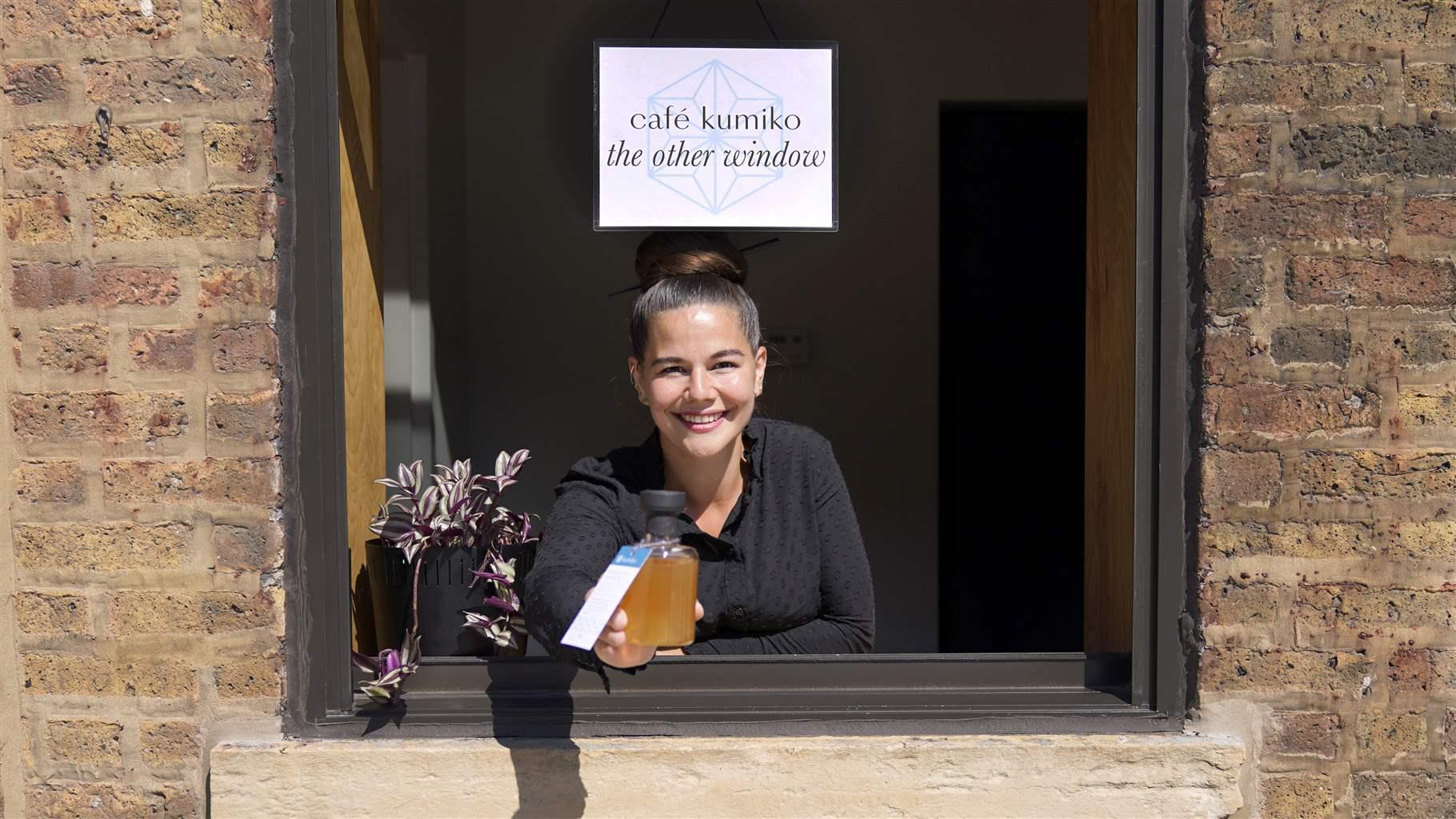 : Texas Governor Signs Cocktails To-Go Bill into Law Julia Momose poses for a portrait at the serving window with a "cocktail to go" at the Kumiko bar in Chicago's West Loop neighborhood Friday, Aug. 14, 2020