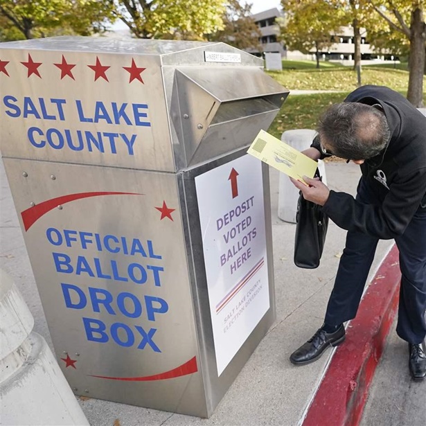 Phil Martinez inserts his ballot into an official ballot drop box Tuesday, Oct. 20, 2020, in Salt Lake City.