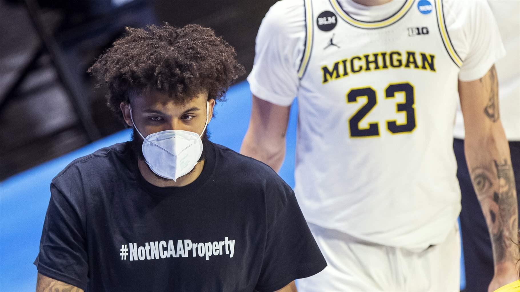 Isaiah Livers wears a T-shirt that reads "#NotNCAAProperty"