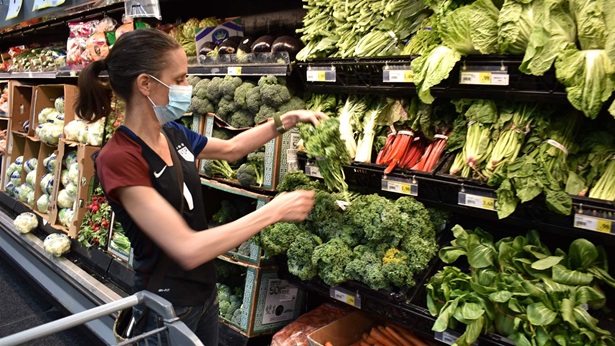 Crystal Dvorak shops at WinCo Foods, Saturday, May, 7, 2021, in Billings, Mont. Dvorak was getting ingredients to make a soup with potatoes and onions she got from a food bank after recently losing her job as an audiologist