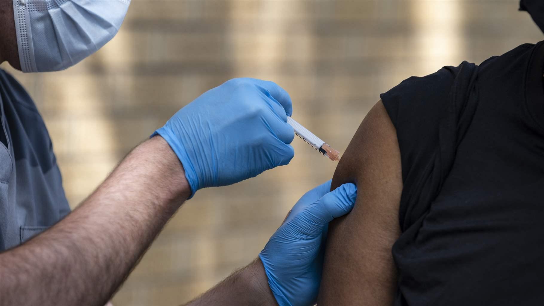 National Guard Specialist Noah Vulpi, left, administers the Johnson & Johnson COVID-19 vaccine to Ira Young Jr during a vaccination clinic held by the National Guard Thursday, May 27, 2021 in Odessa, Texas. 