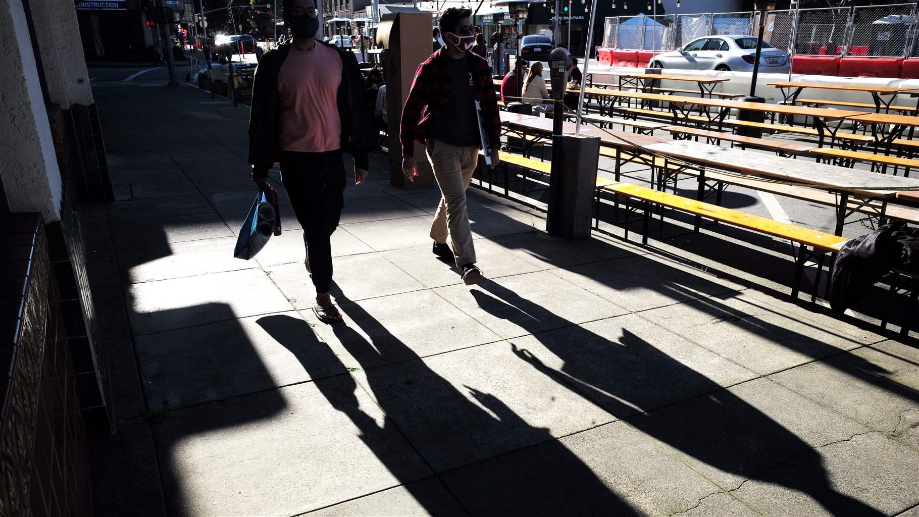 People walk on a business street in San Mateo, California, the United States, Feb. 21, 2021