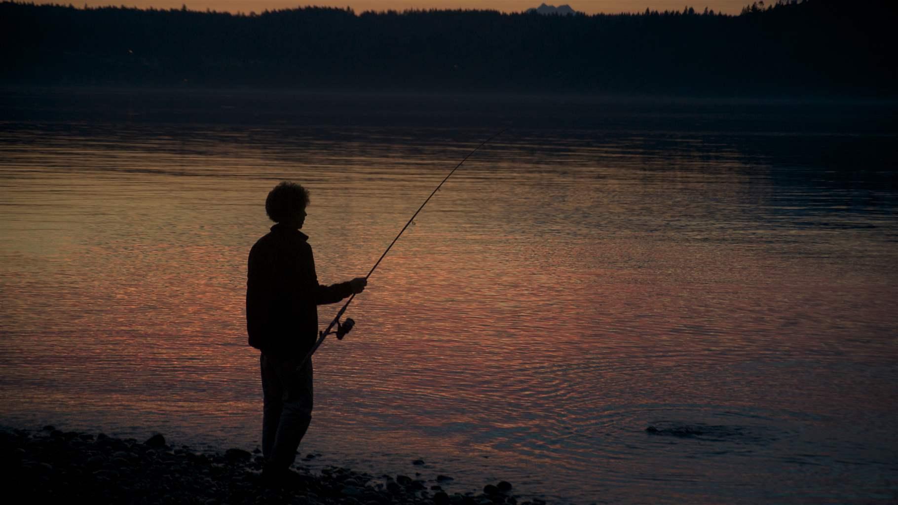 man fishing at Puget Sound