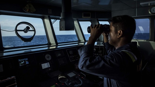 A security ship crew of Ministry of Maritime Affairs and Fisheries observes during a patrol in the South China Sea on August 17, 2016 in Natuna, Ranai, Indonesia.