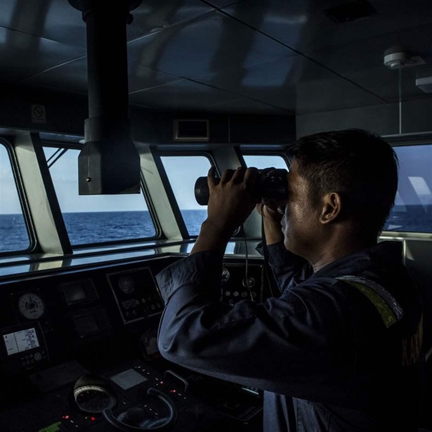 A security ship crew of Ministry of Maritime Affairs and Fisheries observes during a patrol in the South China Sea on August 17, 2016 in Natuna, Ranai, Indonesia.