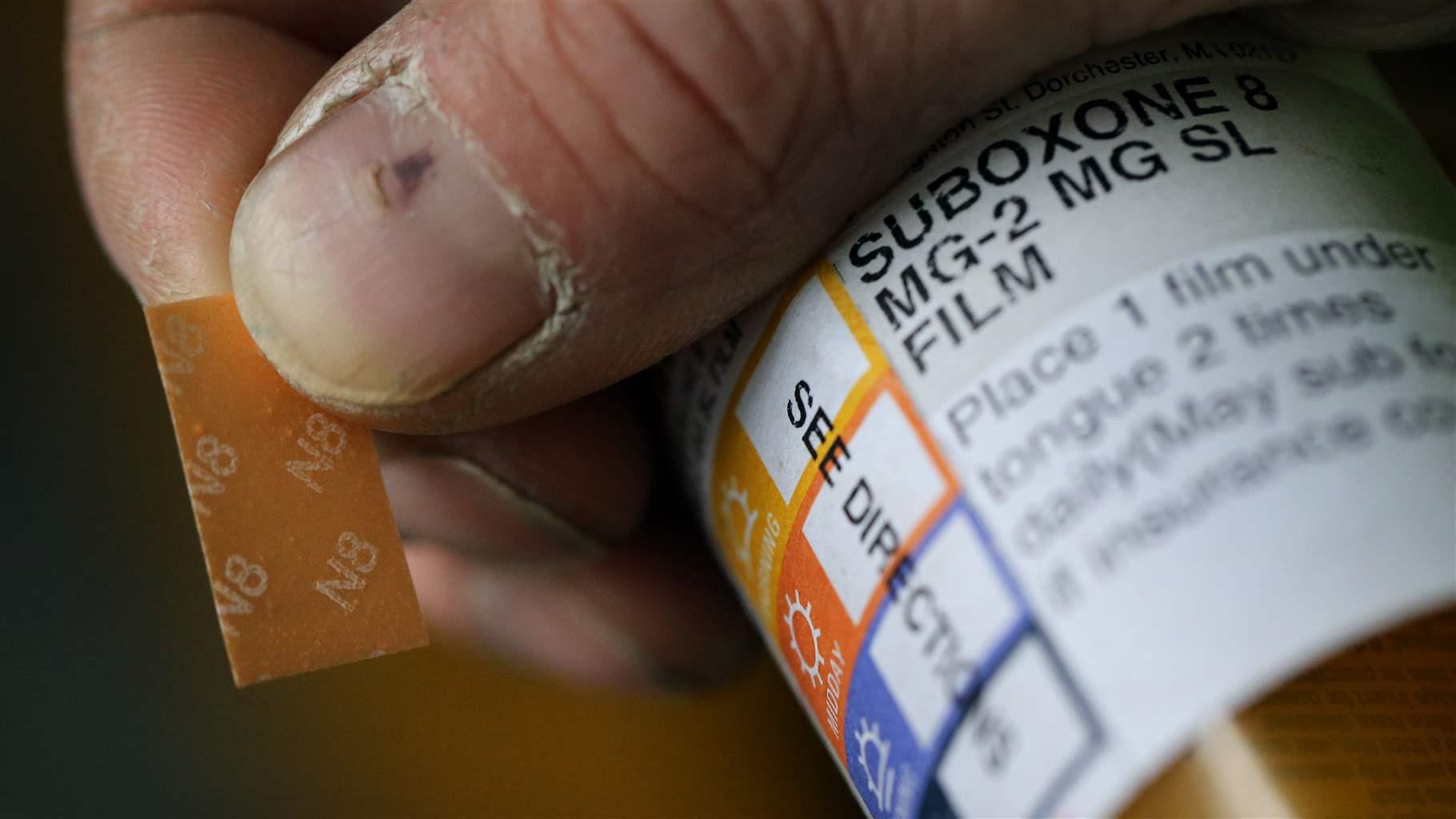 A patient displays his Suboxone prescription following his appointment at the Substance Use Disorders Bridge Clinic at Massachusetts General Hospital in Boston on April 27, 2018. The patient takes Suboxone, a medicine that contains buprenorphine and naloxone, to treat his substance use disorder. He said he had been addicted to Opioids for 10 years but has been drug free since he started taking Suboxone nearly 2 years ago.