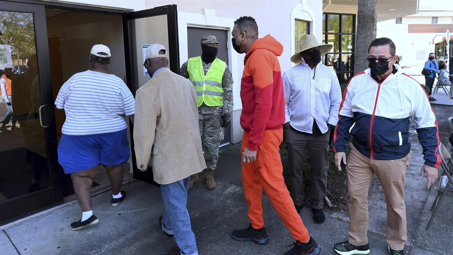People enter Shiloh Baptist Church to receive a dose of the Pfizer COVID-19 vaccine on March 7, 2021 in Orlando, Florida. 