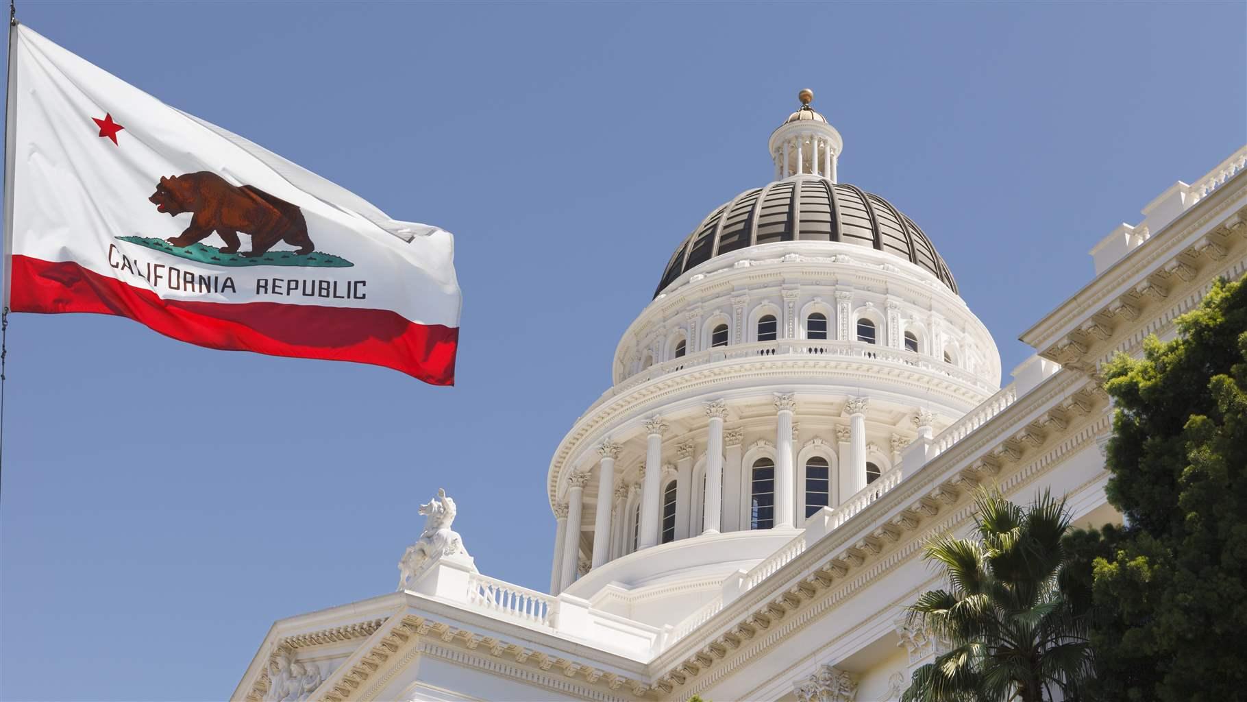 California capitol building with the California waving in mid air