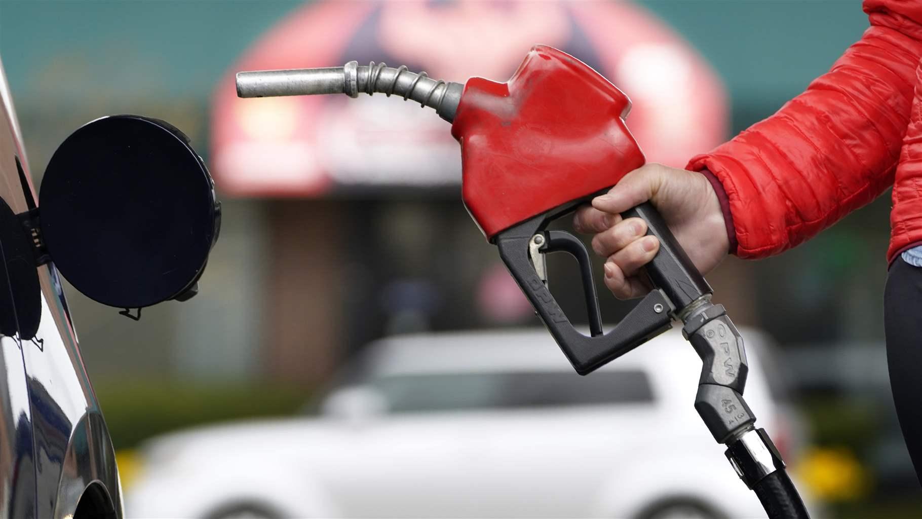 A motorist prepares to pump gas. A New Mexico high court last month ruled that service stations can be sued if they sell gas to drivers who are intoxicated.