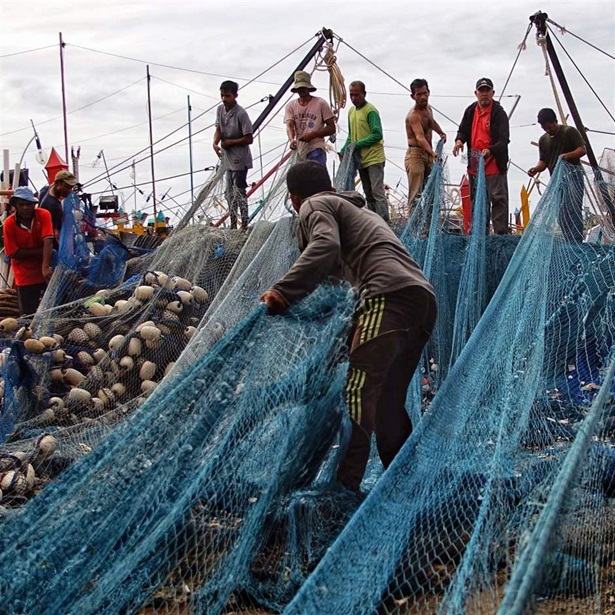 Fishermen at port prepare their vessel and gear for sea.